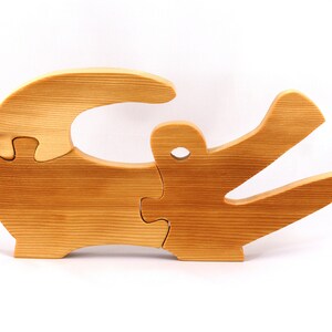 A 10-inch long wooden alligator puzzle for younger kids handmade and smoothly finished. This simple puzzle has three pieces, easy-to-grasp, interlocking, chunky, freestanding pieces. It is made to order.