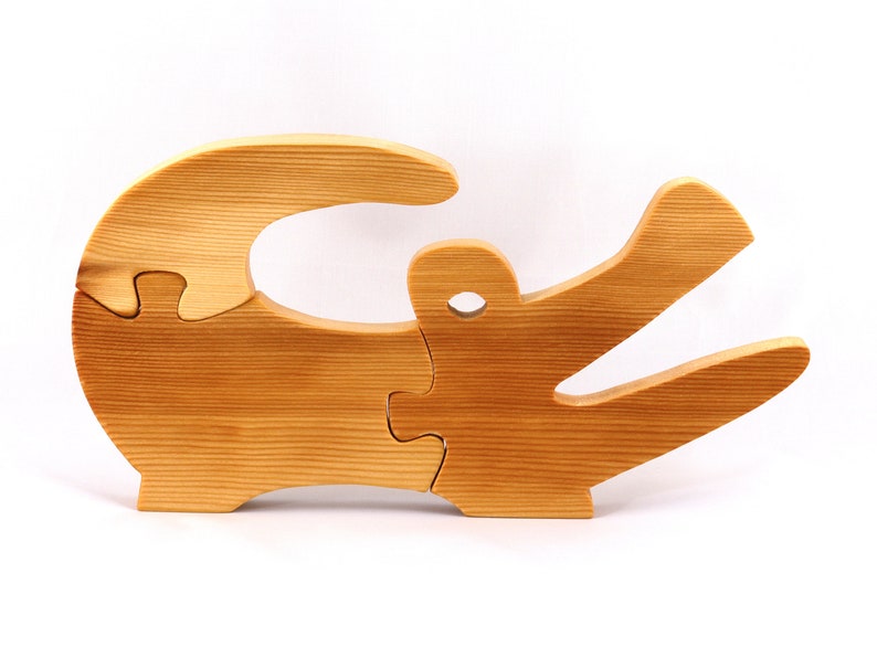 A 10-inch long wooden alligator puzzle for younger kids handmade and smoothly finished. This simple puzzle has three pieces, easy-to-grasp, interlocking, chunky, freestanding pieces. It is made to order.