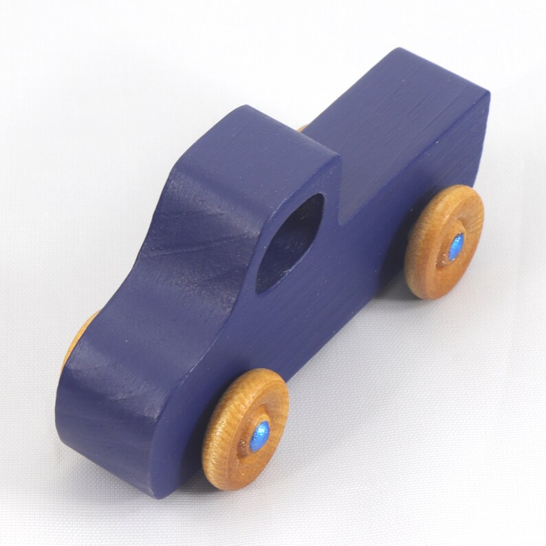 Handmade wooden toy pickup truck handmade and painted navy blue with amber shellac wheels and metallic sapphire blue trim. It's a little blue truck from my Play Pal Collection.