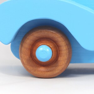 Handmade painted wooden toy car, baby blue convertible with fat fendered roadster design. Non-marring wheels finished with amber shellac.