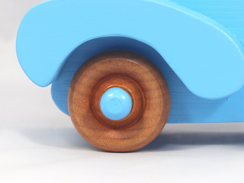 Handmade painted wooden toy car, baby blue convertible with fat fendered roadster design. Non-marring wheels finished with amber shellac.