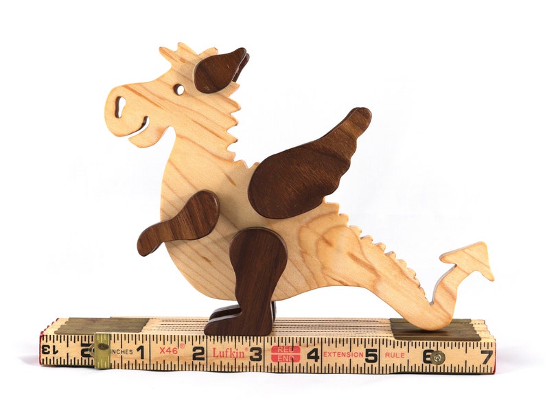 Handmade wood baby dragon fantasy animal figurine made from select grade contrasting hardwoods and hand finished with a durable custom blend of mineral oil and waxes.
