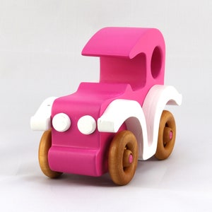 Handmade wooden toy car model-t sedan finished with hot pink and white acrylic paint with nonmaring amber shellac coated spoked wheels from my Bad Bob'S Custom Motors Collection.