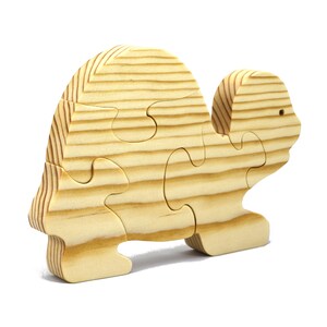 Handmade wooden turtle puzzle with 5 simple interlocking pieces. Freestanding 5-piece wooden puzzle. Approximate dimensions: 5 inches high by 7.25 inches long by 0.75 inches thick. Finished with mineral oil and beeswax blend. Handcrafted in Tallahassee, Florida, USA, using natural wood. Unique wood grain color and knot variations. Odin’s Toy Factory.