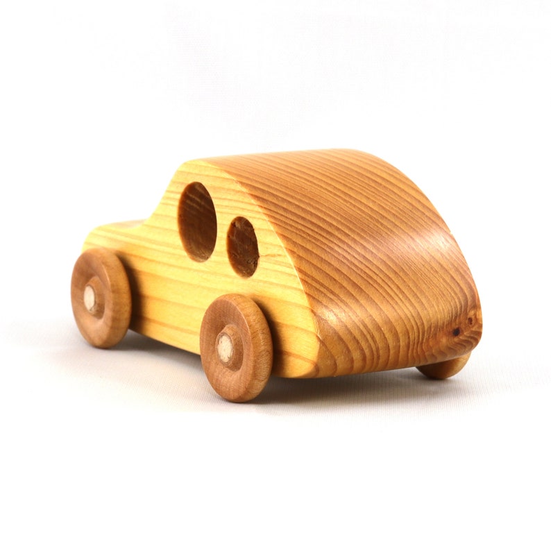 A handmade wooden toy car from the My Play Pal collection finished with durable satin polyurethane and amber shellac. It is made to order.