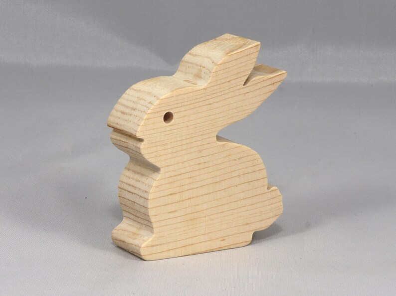 This is an unfinished wooden Rabbit cutout from solid wood using traditional woodworking techniques. Sanded smooth and ready to paint, stain, or customize. Freestanding design for small hands, toddlers, young children, crafters, collectors, and display. I take custom orders for any animal, quantity, and mix — including large ornament orders. Mix and match, request a different size, or send a drawing or pattern. Handmade by Odin's Toy Factory in Tallahassee, Florida, USA.