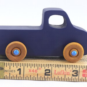 Handmade wooden toy pickup truck handmade and painted navy blue with amber shellac wheels and metallic sapphire blue trim. It's a little blue truck from my Play Pal Collection.