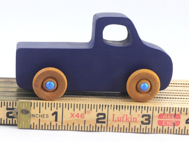 Handmade wooden toy pickup truck handmade and painted navy blue with amber shellac wheels and metallic sapphire blue trim. It's a little blue truck from my Play Pal Collection.