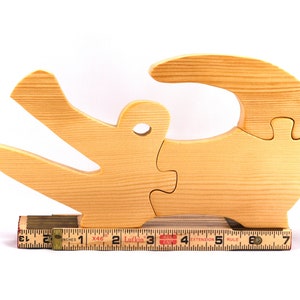 A 10-inch long wooden alligator puzzle for younger kids handmade and smoothly finished. This simple puzzle has three pieces, easy-to-grasp, interlocking, chunky, freestanding pieces. It is made to order.