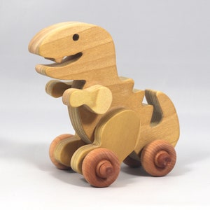 Handmade wooden push toy Tyrannosaurus Rex dinosaur made from select grade hardwoods and finished with a non-toxic coating.