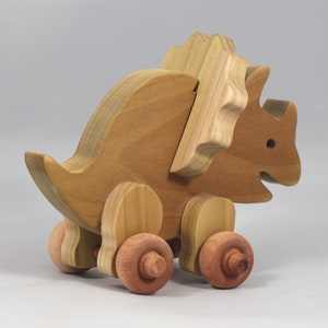 Handmade wooden push toy Triceratops dinosaur made from select grade hardwoods and finished with a non-toxic coating.