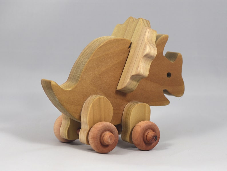 Handmade wooden push toy Triceratops dinosaur made from select grade hardwoods and finished with a non-toxic coating.