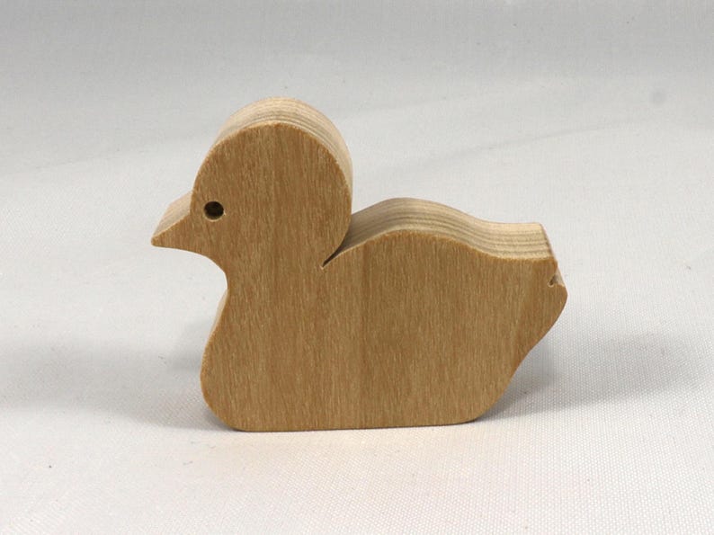 This is an unfinished wooden Duck cutout from solid wood using traditional woodworking techniques. Sanded smooth and ready to paint, stain, or customize. Freestanding design for small hands, toddlers, young children, crafters, collectors, and display. I take custom orders for any animal, quantity, and mix — including large ornament orders. Mix and match, request a different size, or send a drawing or pattern. Handmade by Odin's Toy Factory in Tallahassee, Florida, USA.