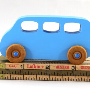 A Handmade wood toy mini van hand-painted baby blue with metallic sapphire blue trim and wheels finished with nonmarring amber shellac from my Play Pall Collection.