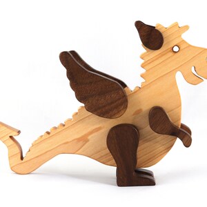 Handmade wood baby dragon fantasy animal figurine made from select grade contrasting hardwoods and hand finished with a durable custom blend of mineral oil and waxes.