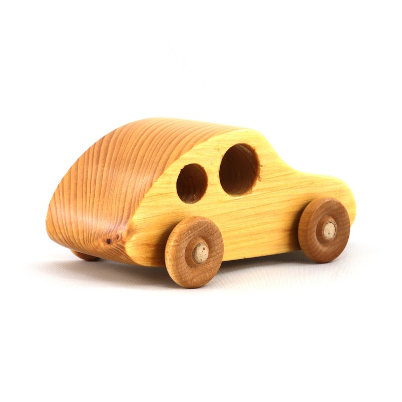 A handmade wooden toy car from the My Play Pal collection finished with durable satin polyurethane and amber shellac. It is made to order.