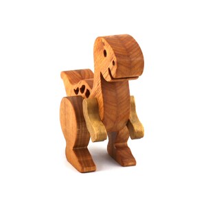 A wooden baby dinosaur figurine handmade and finished from select-grade hardwoods. It is an excellent toy for kids of any age. It is one of several dinosaurs in my collection.