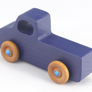 Handmade wooden toy pickup truck handmade and painted navy blue with amber shellac wheels and metallic sapphire blue trim. It's a little blue truck from my Play Pal Collection.