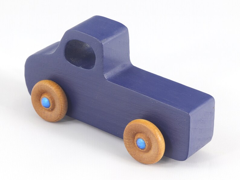Handmade wooden toy pickup truck handmade and painted navy blue with amber shellac wheels and metallic sapphire blue trim. It's a little blue truck from my Play Pal Collection.