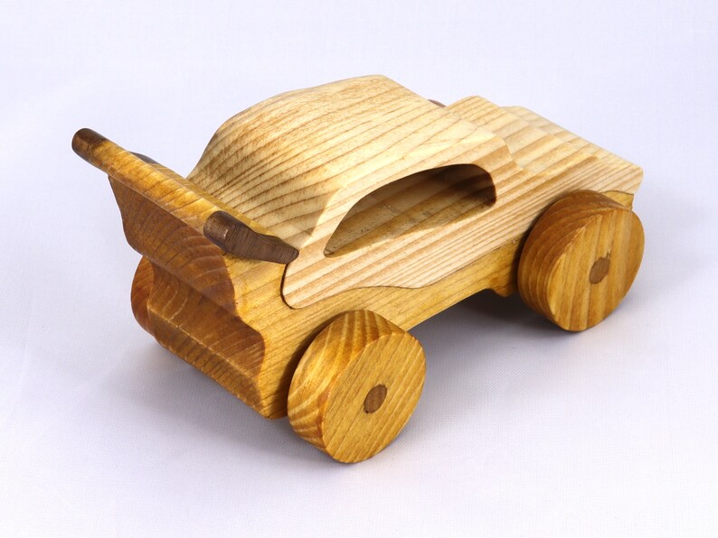 Handmade wooden toy car finished with nontoxic clear amber shellac and contrasting wood trim. Part of the Speedy Wheels Collection. Handcrafted in Tallahassee, Florida, USA. Length 5-1/2 inches, width 2-1/2 inches, height 2-1/2 inches. Made at Odin's Toy Factory.