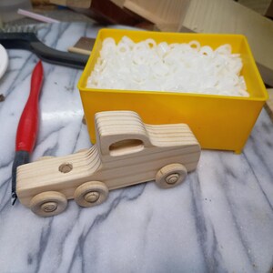 Handmade wooden toy tractor trailer semi truck finished with clear shellac. Crafted from natural wood using traditional woodworking tools. Approximate size 7 inches long. Made in Tallahassee, Florida, USA from Odin's Toy Factory Play Pal Collection.