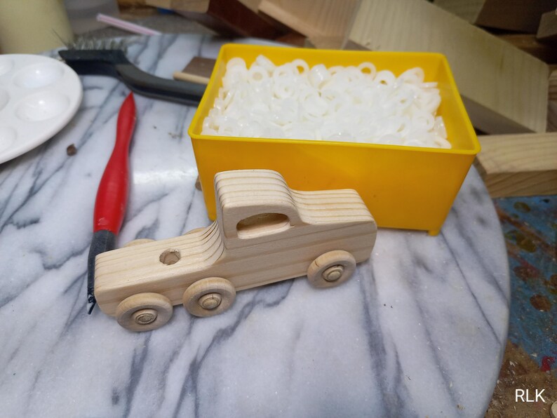 Handmade wooden toy tractor trailer semi truck finished with clear shellac. Crafted from natural wood using traditional woodworking tools. Approximate size 7 inches long. Made in Tallahassee, Florida, USA from Odin's Toy Factory Play Pal Collection.