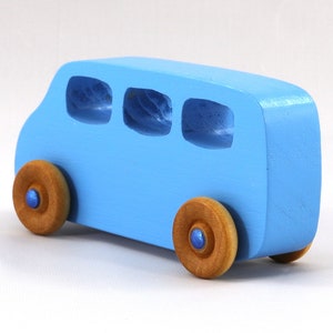 A Handmade wood toy mini van hand-painted baby blue with metallic sapphire blue trim and wheels finished with nonmarring amber shellac from my Play Pall Collection.