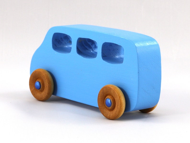 A Handmade wood toy mini van hand-painted baby blue with metallic sapphire blue trim and wheels finished with nonmarring amber shellac from my Play Pall Collection.