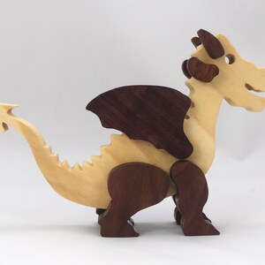 Wood Dragon Fantasy Animal Figurine is Handmade and finished with a renewable blend of mineral oil and waxes Applied hot for durabiliity and to enhance the beauty of the wood. There are ten dragons in this collection. A  link is in the description.