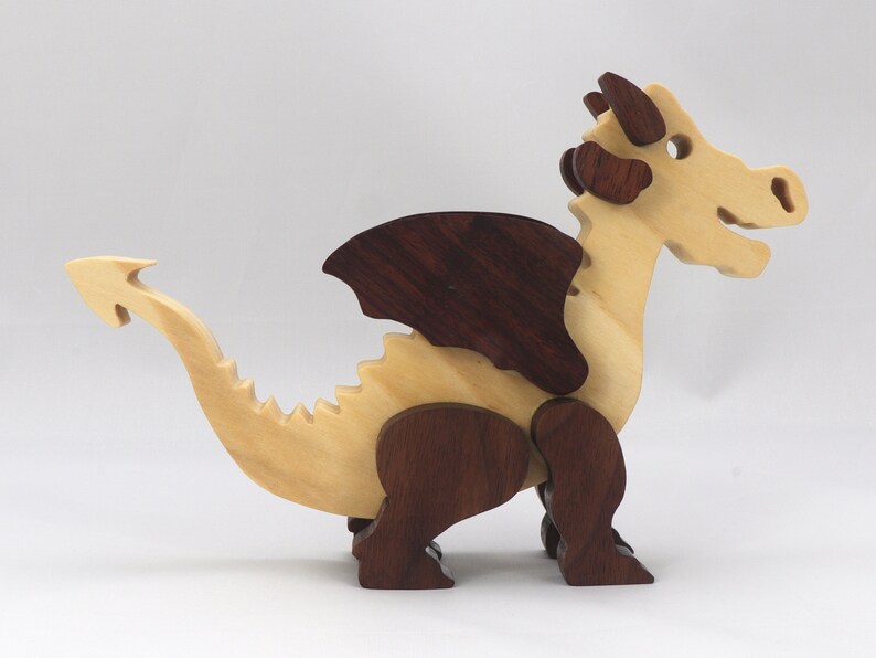Wood Dragon Fantasy Animal Figurine is Handmade and finished with a renewable blend of mineral oil and waxes Applied hot for durabiliity and to enhance the beauty of the wood. There are ten dragons in this collection. A  link is in the description.
