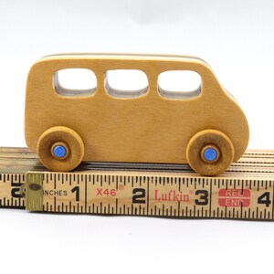 Handmade wood toy minivan made by me in my shop using traditional woodworking tools. It is hand finished with clear shellac with metallic sapphire blue acrylic paint.