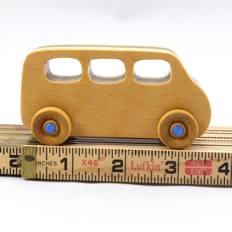 Handmade wood toy minivan made by me in my shop using traditional woodworking tools. It is hand finished with clear shellac with metallic sapphire blue acrylic paint.