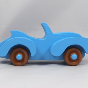Handmade painted wooden toy car, baby blue convertible with fat fendered roadster design. Non-marring wheels finished with amber shellac.