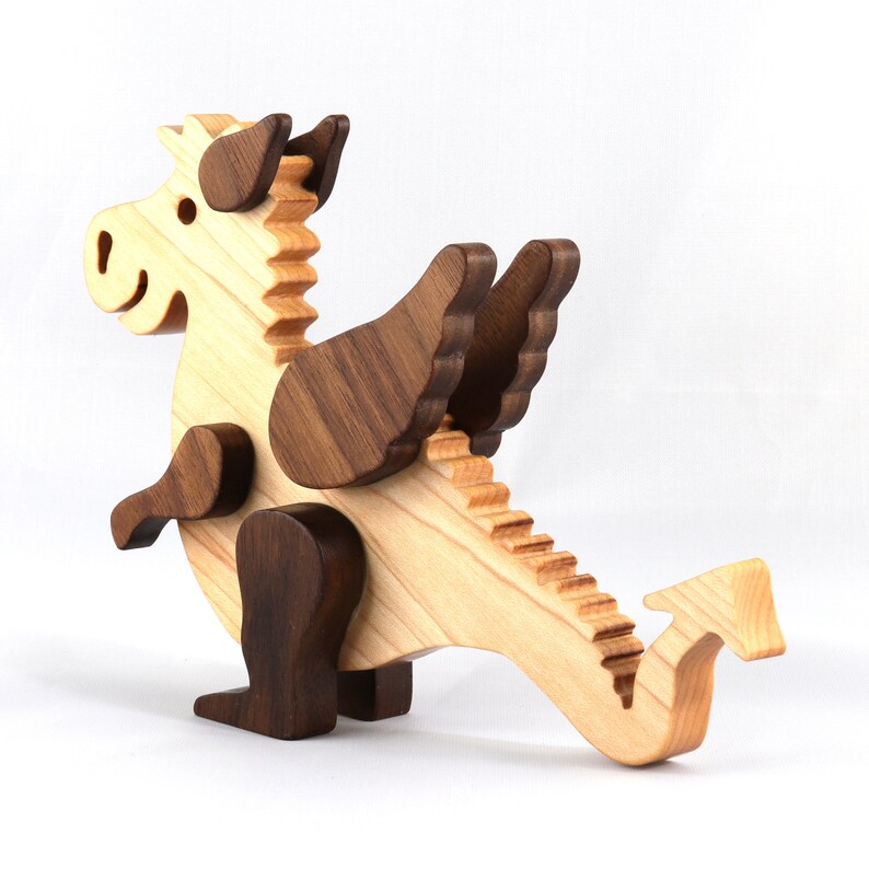 Handmade wood baby dragon fantasy animal figurine made from select grade contrasting hardwoods and hand finished with a durable custom blend of mineral oil and waxes.