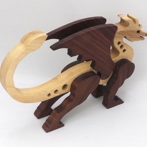 Handmade wood dragon figurine made from select grade contrasting hardwoods and hand-finished with a custom mixture of mineral oil and waxes.