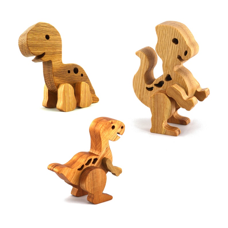 Handmade wooden baby dinosaur figurines, set of 3, made from hardwood with a natural oil and wax finish. Each baby dinosaur measures approximately 3 to 4 inches in height and length. Handmade in Tallahassee, Florida, USA at Odin's Toy Factory.
