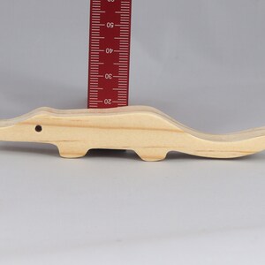 Handmade toy alligator cutout from the Itty Bitty Animal Collection. Crafted with traditional woodworking tools, this unfinished wood alligator is freestanding, smooth-sanded, and ready to paint. Perfect for stacking and imaginative play.