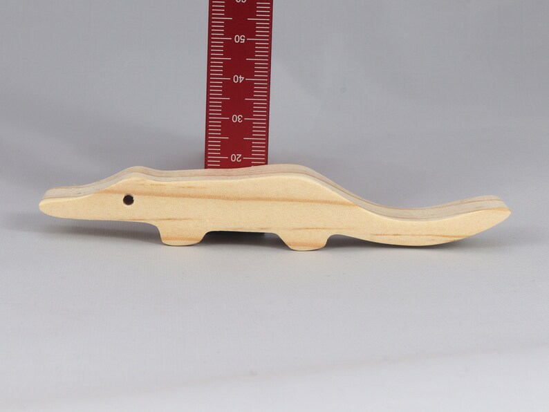 Handmade toy alligator cutout from the Itty Bitty Animal Collection. Crafted with traditional woodworking tools, this unfinished wood alligator is freestanding, smooth-sanded, and ready to paint. Perfect for stacking and imaginative play.