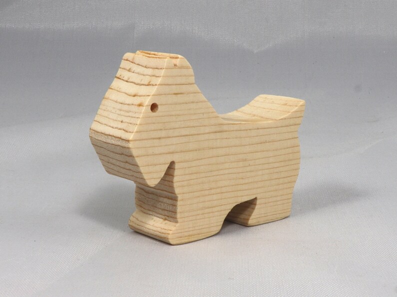 Handmade wood toy Scottie dog cutout unfinished unpainted paintable freestanding Itty Bitty Animal Collection. Approximate size 2.5 inches length by 2 inches height by 0.75 inches width. Handmade in Tallahassee Florida USA from natural wood offcuts.