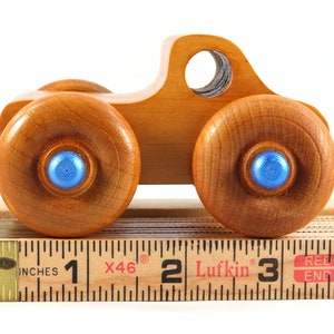 Wood Toy Monster Truck Handmade Form Hardwood and Finished With Amber Shellac With Metallic Saphire Blue Trim.
