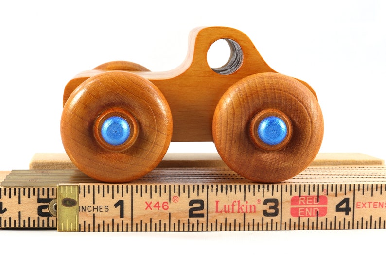 Wood Toy Monster Truck Handmade Form Hardwood and Finished With Amber Shellac With Metallic Saphire Blue Trim.