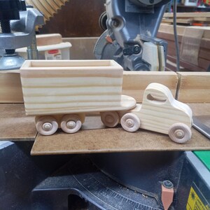 Handmade wooden toy tractor trailer semi truck finished with clear shellac. Crafted from natural wood using traditional woodworking tools. Approximate size 7 inches long. Made in Tallahassee, Florida, USA from Odin's Toy Factory Play Pal Collection.