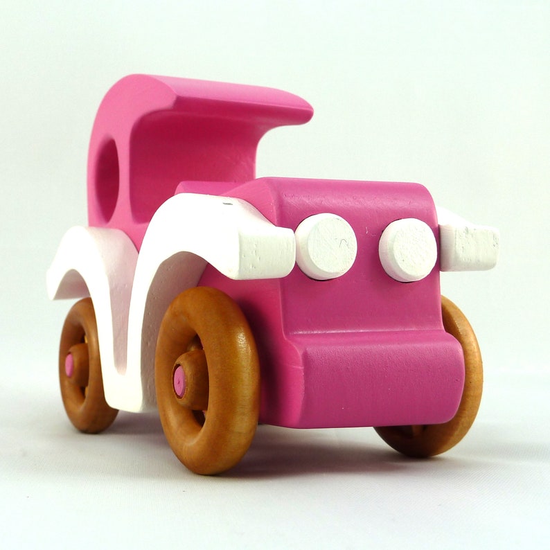 Handmade wooden toy car model-t sedan finished with hot pink and white acrylic paint with nonmaring amber shellac coated spoked wheels from my Bad Bob'S Custom Motors Collection.
