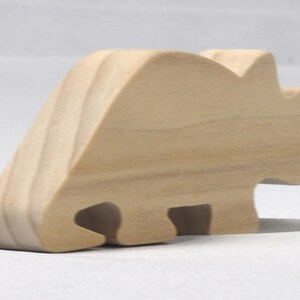 This is an unfinished wooden Wooden Toy Dinosaur Triceratops cutout from solid wood using traditional woodworking techniques. Sanded smooth and ready to paint, stain, or customize. Freestanding design for small hands, toddlers, young children, crafters, collectors, and display. I take custom orders for any animal, quantity, and mix — including large ornament orders. Mix and match, request a different size, or send a drawing or pattern. Handmade by Odin's Toy Factory in Tallahassee, Florida, USA.