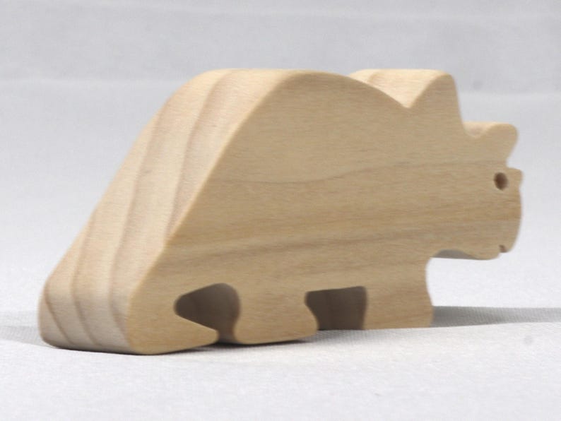 This is an unfinished wooden Wooden Toy Dinosaur Triceratops cutout from solid wood using traditional woodworking techniques. Sanded smooth and ready to paint, stain, or customize. Freestanding design for small hands, toddlers, young children, crafters, collectors, and display. I take custom orders for any animal, quantity, and mix — including large ornament orders. Mix and match, request a different size, or send a drawing or pattern. Handmade by Odin's Toy Factory in Tallahassee, Florida, USA.