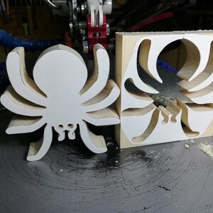 Handmade unfinished wooden Halloween spider cutout from Odin's Toy Factory Snazzy Spooks Collection. Solid wood hand-cut spider, paintable, freestanding design. Approximate size 3.5 inches height by 3.5 inches width by 0.75 inches thick. Made in Tallahassee, Florida, USA.