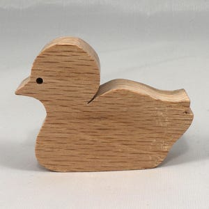 This is an unfinished wooden Duck cutout from solid wood using traditional woodworking techniques. Sanded smooth and ready to paint, stain, or customize. Freestanding design for small hands, toddlers, young children, crafters, collectors, and display. I take custom orders for any animal, quantity, and mix — including large ornament orders. Mix and match, request a different size, or send a drawing or pattern. Handmade by Odin's Toy Factory in Tallahassee, Florida, USA.