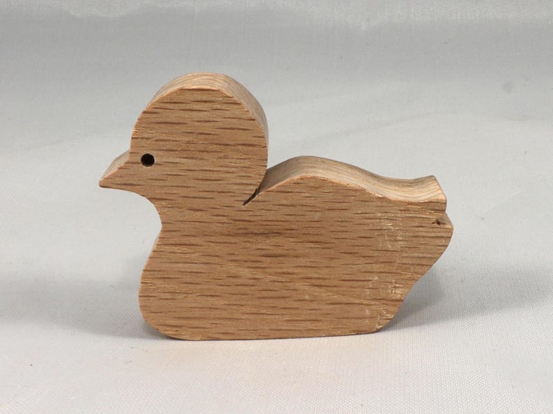 This is an unfinished wooden Duck cutout from solid wood using traditional woodworking techniques. Sanded smooth and ready to paint, stain, or customize. Freestanding design for small hands, toddlers, young children, crafters, collectors, and display. I take custom orders for any animal, quantity, and mix — including large ornament orders. Mix and match, request a different size, or send a drawing or pattern. Handmade by Odin's Toy Factory in Tallahassee, Florida, USA.