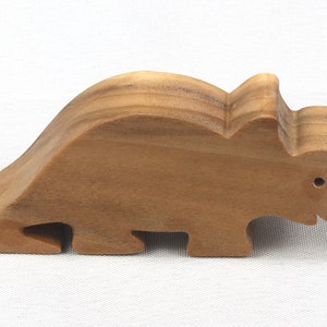 This small wooden triceratops dinosaur toy is crafted from high-quality hardwood and hand-finished. It is a delightful plaything for young children and appeals to many adults.