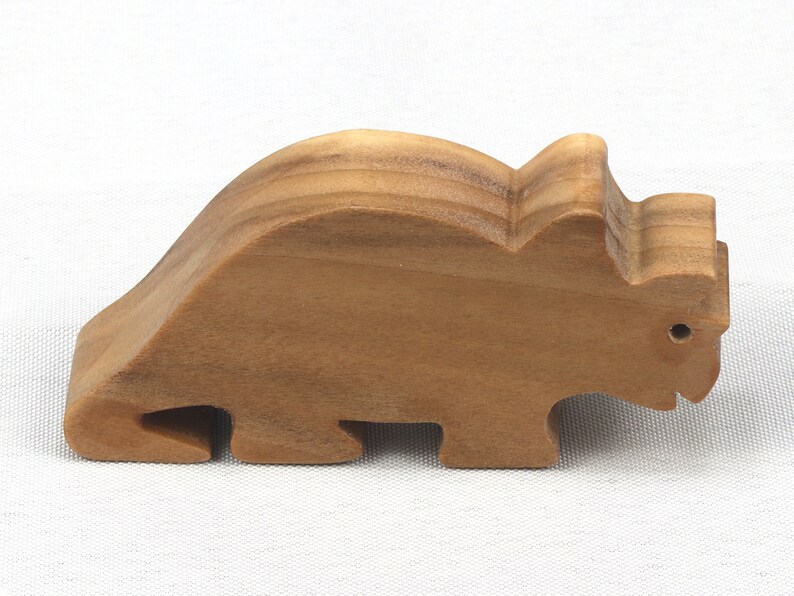 This small wooden triceratops dinosaur toy is crafted from high-quality hardwood and hand-finished. It is a delightful plaything for young children and appeals to many adults.